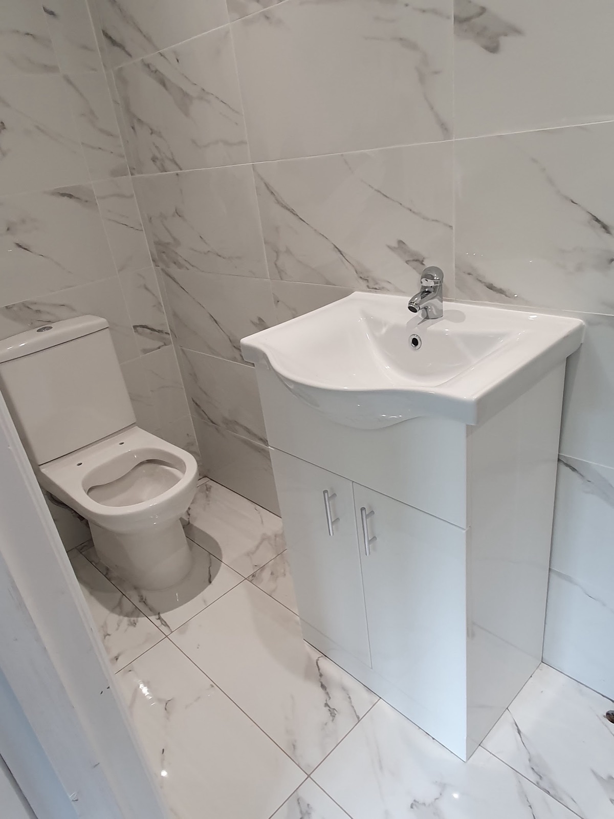 white marble cloakroom, toilet and basin